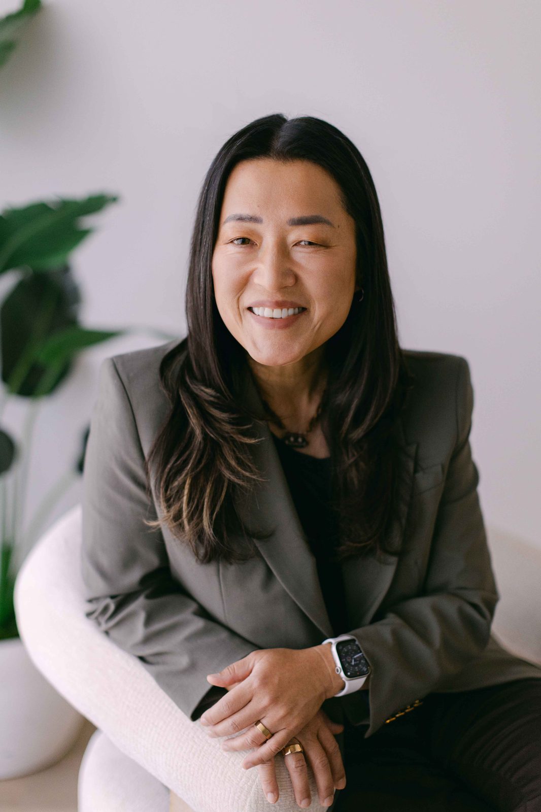 Kim Polinder seated in a chair, smiling
